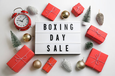 Lightbox with phrase BOXING DAY SALE and Christmas decorations on white background, flat layの写真素材