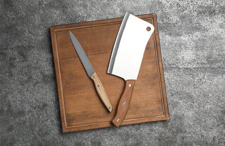 Knives on gray table, top view. Cooking utensils