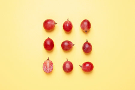 Flat lay composition with fresh ripe grapes on yellow backgroundの写真素材