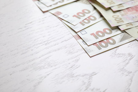 Ukrainian money on white wooden background, closeup. Space for textの写真素材