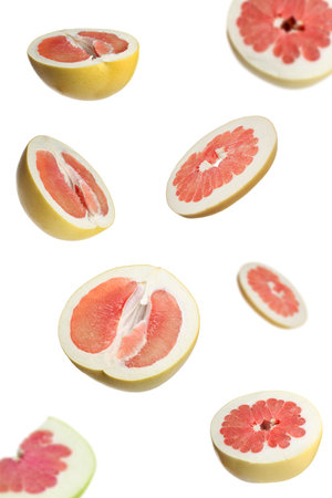 Fresh exotic pomelo fruits falling on white backgroundの写真素材