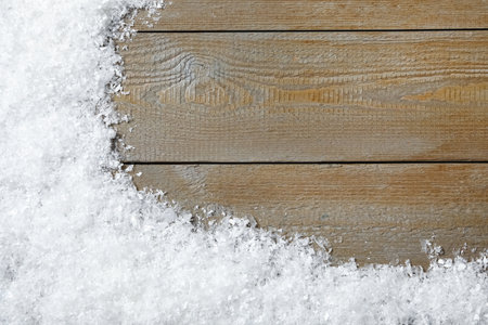 Snow and space for text on wooden background, top view. Christmas timeの写真素材