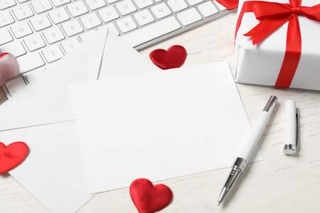 Composition with blank card on white wooden table, space for text. Valentine's Day celebrationの写真素材