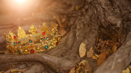 Beautiful golden crown on tree roots outdoors. Fantasy itemの写真素材