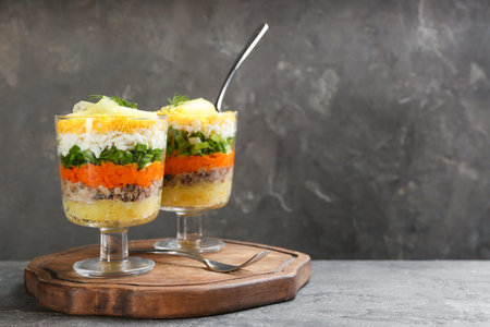 Traditional russian salad Mimosa on grey table, space for textの写真素材