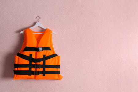 Orange life jacket on pink background. Space for textの写真素材