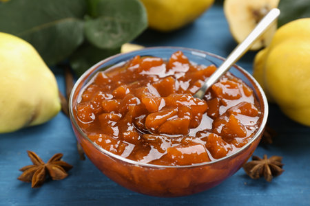Delicious quince jam on blue wooden table, closeupの写真素材