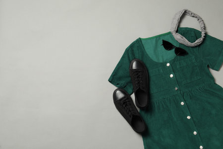 Flat lay composition with stylish green dress on gray background. Space for textの写真素材