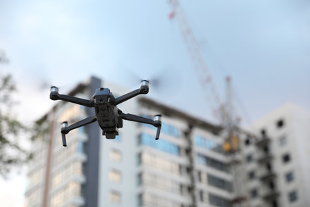 Modern drone flying at building site. aerial photographyの写真素材