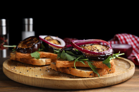 Delicious fresh eggplant sandwiches served on wooden tableの写真素材