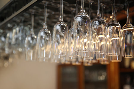 Many clean glasses on metal rack in restaurantの写真素材