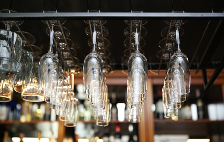 Many clean glasses on metal rack in restaurantの写真素材