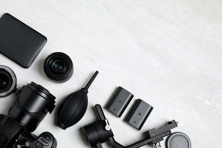 Camera and video production equipment on light background, flat lay. Space for textの写真素材