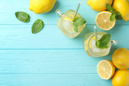 Natural lemonade with mint on light blue wooden table, flat lay and space for text. summer refreshing drinkの写真素材