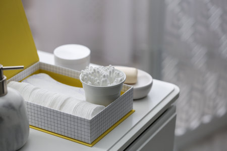 Cotton buds and pads in box on white table indoorsの写真素材