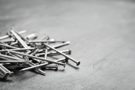 Many metal nails on gray background. Space for textの写真素材
