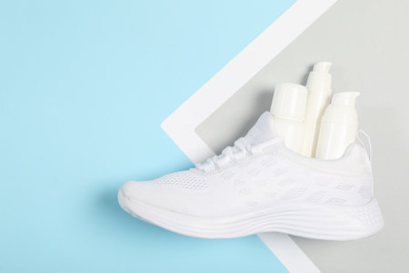 Stylish footwear with shoe care accessories on color background, top viewの写真素材