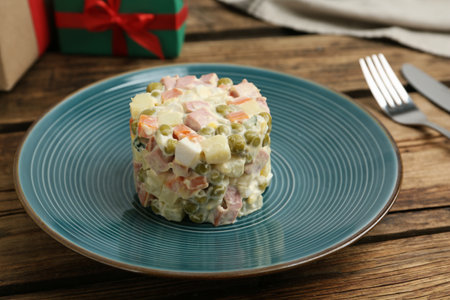 Traditional russian salad Olivier served on wooden tableの写真素材