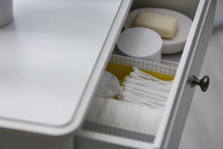 Open drawer with cotton buds and pads indoors , above viewの写真素材