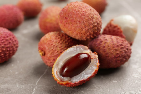 Fresh ripe lychee fruits on grey table, closeupの写真素材
