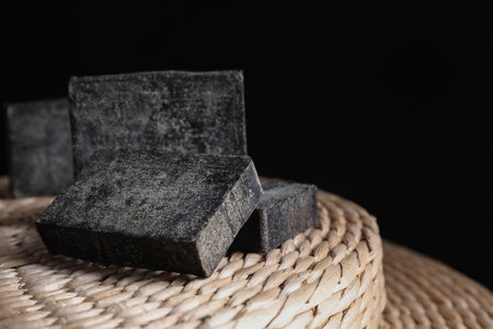 Natural tar soap on wicker pouf, closeupの写真素材