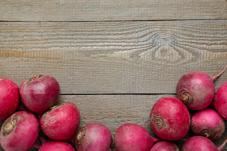 Red turnips on wooden table, flat lay. Space for textの写真素材