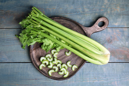 Fresh ripe celery on blue wooden table, top viewの写真素材