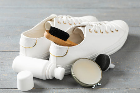 Composition with stylish footwear and shoe care accessories on grey wooden backgroundの写真素材