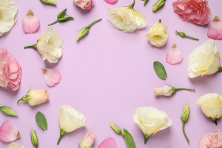 Frame of beautiful Eustoma flowers on violet background, flat lay. Space for textの写真素材