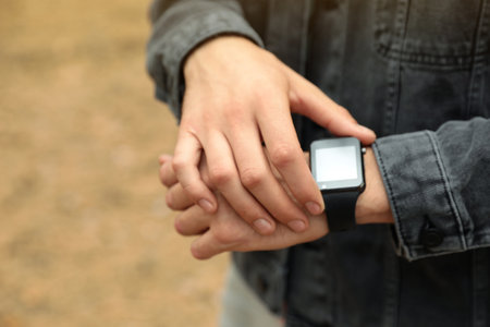 Man using stylish smart watch outdoors, closeupの写真素材