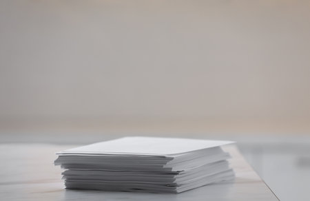 Stack of blank paper sheets on table in office, closeupの写真素材