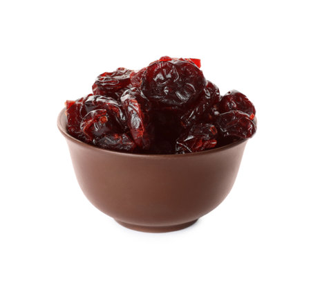 Dried cranberries in bowl isolated on whiteの写真素材