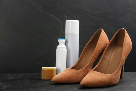 Stylish footwear with shoe care accessories on black tableの写真素材
