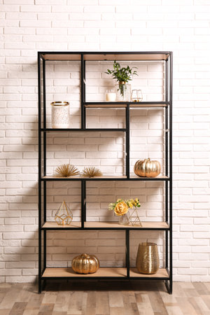 Shelving with different decor near white brick wall. interior designの写真素材