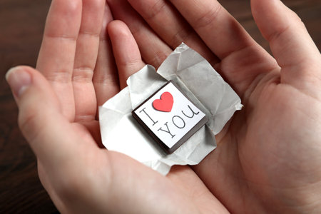 Woman holding chocolate candy with message I Love You, closeupの写真素材