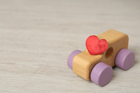 Wooden toy with and decorative heart on table, space for text. Happy Valentine's Dayの写真素材