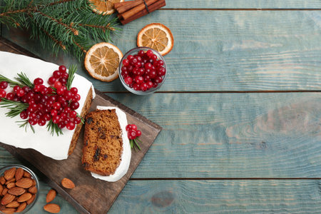 Traditional Christmas cake and ingredients on light blue wooden table, flat lay with space for text. classic recipeの写真素材