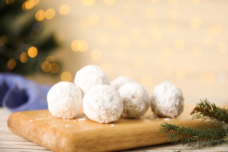 Christmas snowball cookies on light table against blurred lights, closeupの写真素材