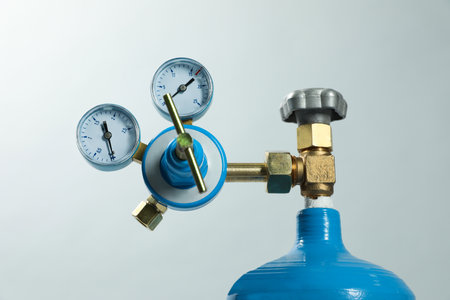 Pressure gauge of medical oxygen tank on light gray background, closeup