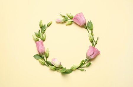 Frame of beautiful Eustoma flowers on beige background, flat lay. Space for textの写真素材