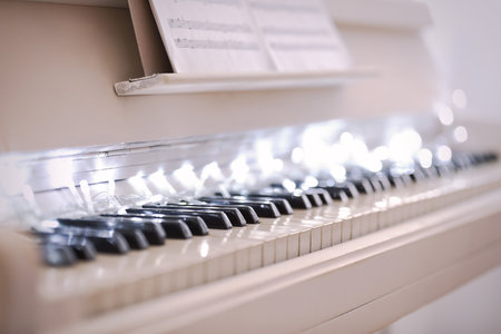 Glowing fairy lights on piano keys, closeup. christmas musicの写真素材