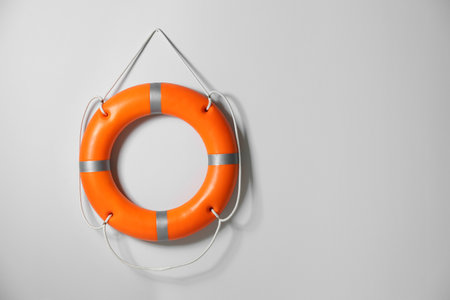 Orange lifebuoy on light background. Space for textの写真素材