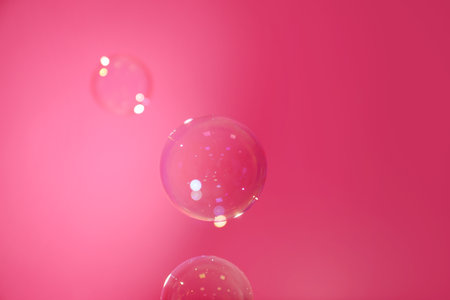 Beautiful translucent soap bubbles on pink backgroundの写真素材
