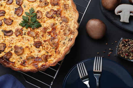 Flat lay composition with delicious homemade mushroom pie on black tableの写真素材