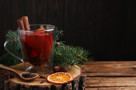 Tasty aromatic mulled wine on wooden table, space for textの写真素材