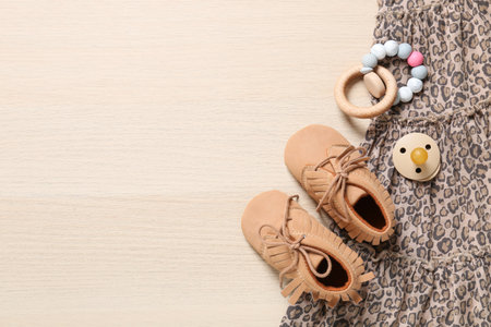 Flat lay composition with cute baby outfit on wooden backgroundの写真素材