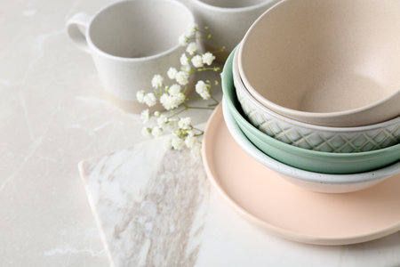 Different dishware and marble board on table, space for textの写真素材
