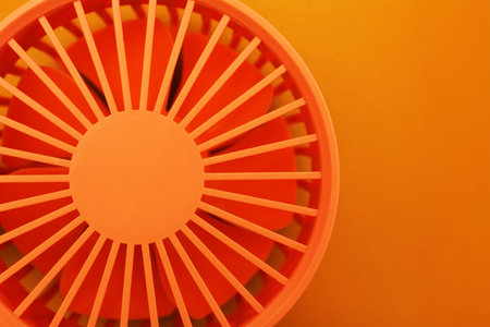 Bright portable fan on orange background, top viewの写真素材