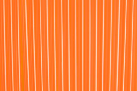 Many orange plastic drinking straws as background, closeupの写真素材