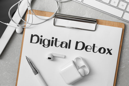 Flat lay composition of clipboard with words DIGITAL DETOX on light gray marble backgroundの写真素材